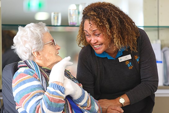 IRT carer smiling with elderly woman in retirement village