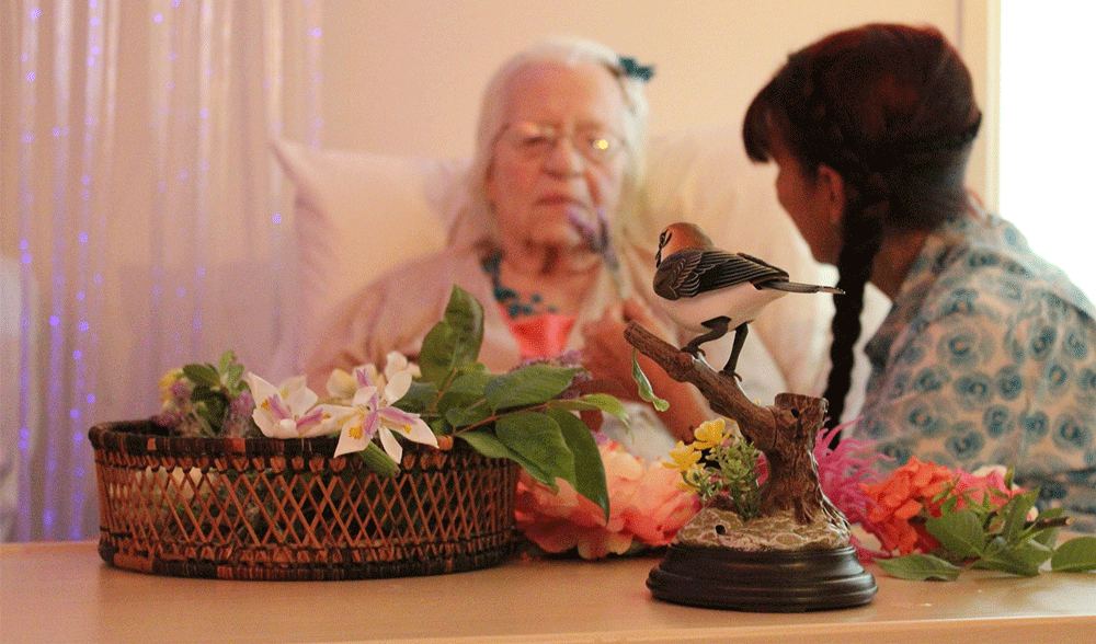 Nurse helping woman in palliative care