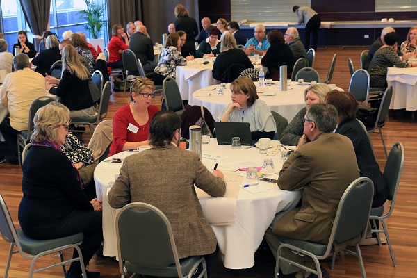 People sitting at roundtable dicussing mature workfroce