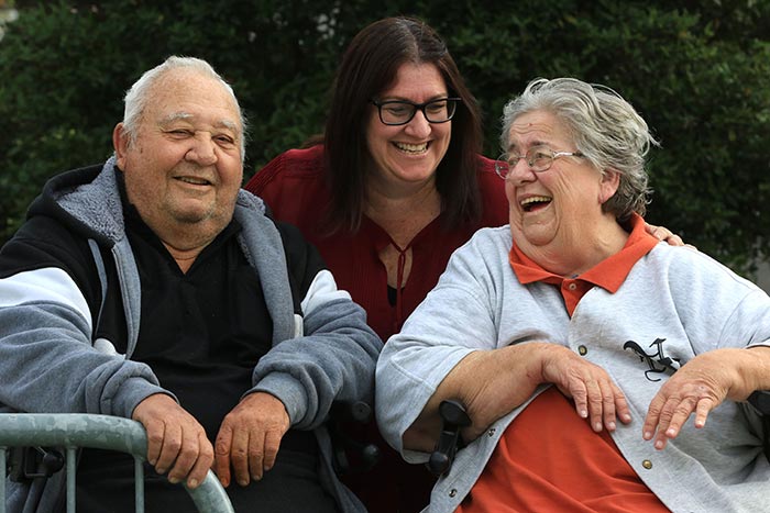 Worker helping older couple