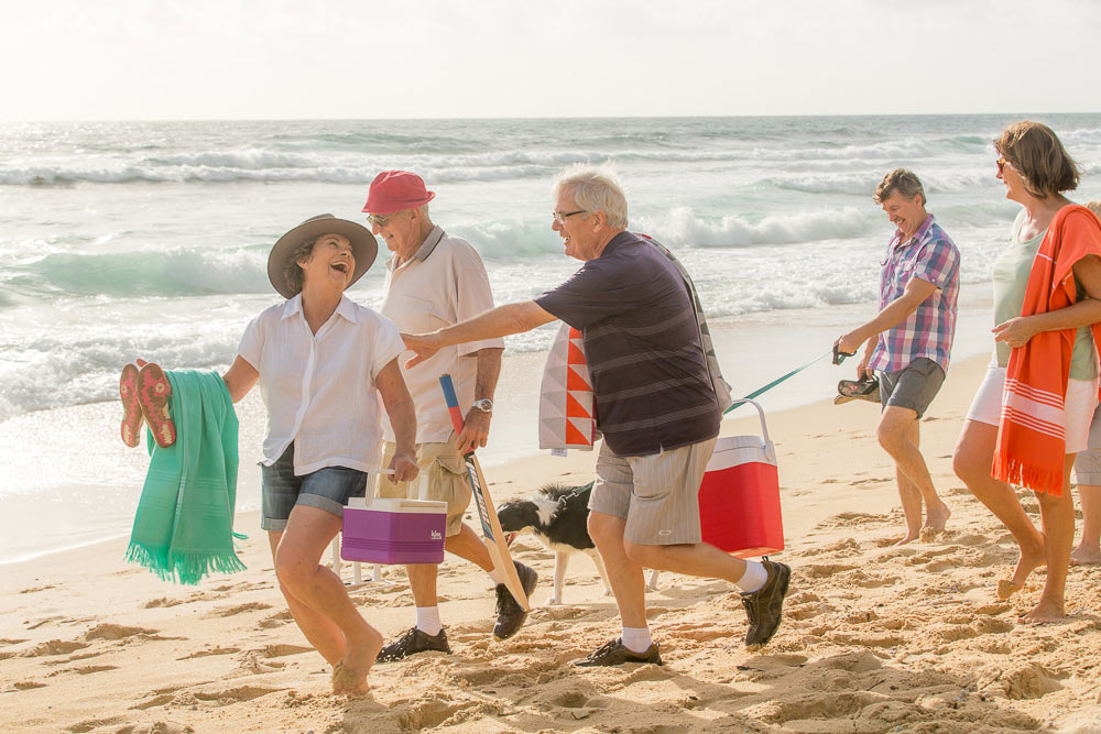 Retirees laughing on the beach